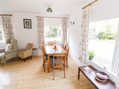 a living room with a table and chairs and a window at Lakeside in Ballinrobe