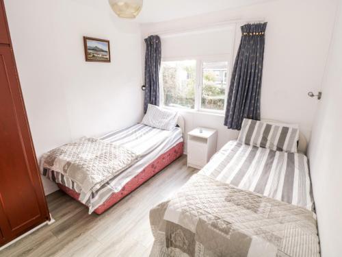 a bedroom with two beds and a window at Lakeside in Ballinrobe
