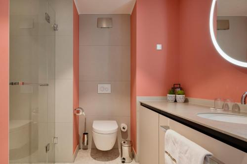 ein Bad mit einem WC, einem Waschbecken und einer Dusche in der Unterkunft Elisapart - Apartments am Sommerschloss in Potsdam