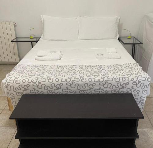 a black and white bed with two tables on it at Tourist House Bologna - Self check-in in Bologna