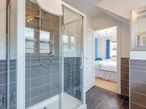 a bathroom with a shower with a glass door at The Lookout in Aviemore