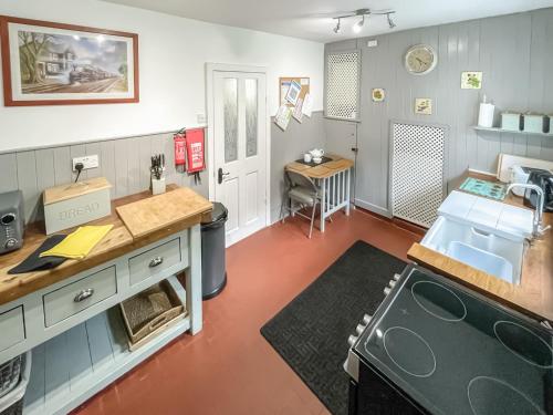a kitchen with a sink and a counter top at Meredith Cottage in Dolwyddelan
