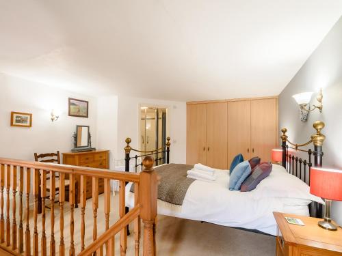 a bedroom with a bed and a staircase at Cove View Cottage in Malham