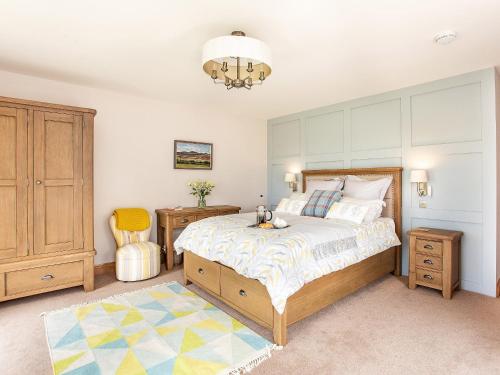 a bedroom with a bed and a table and a chair at Morven View in Dunbeath