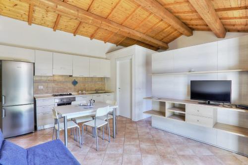 a kitchen with a table and chairs in a kitchen at Villaggio Le Venelle in Rio Marina