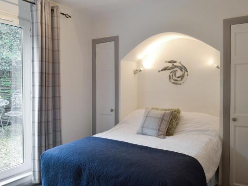 a bedroom with a bed and a large window at The Nook in Woolacombe