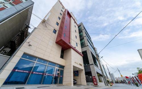 a building with a large window on the side of it at Hotel MoMo in Busan