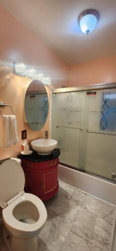 a bathroom with a toilet and a sink and a mirror at Hollywood apartment 
