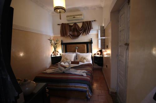 a bedroom with a bed with towels on it at Riad Eloise in Marrakesh