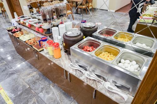 a buffet with several trays of food on a table at Hamit Hotel Kizilay in Ankara