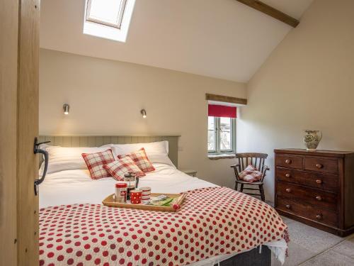 a bedroom with a bed with a tray on it at Long Barn - Ukc2870 in Baltonsborough