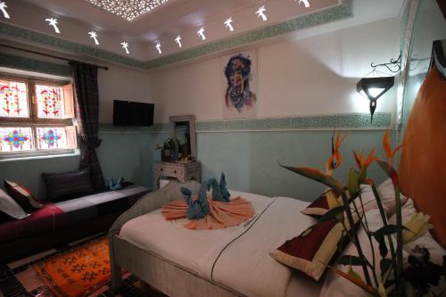 - une chambre avec un lit, un canapé et une fenêtre dans l'établissement Riad Eloise, à Marrakech