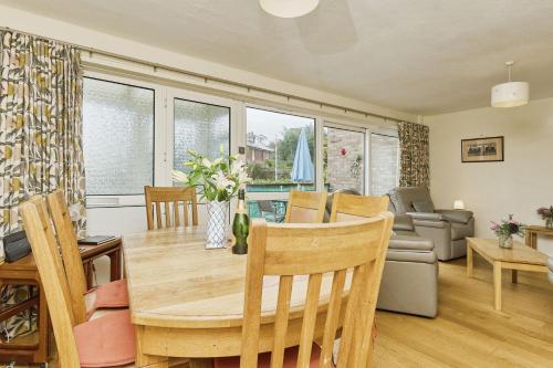a dining room and living room with a table and chairs at 3 Harbour Strand in Bembridge