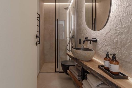 a bathroom with a sink and a mirror at Hill Palanga & SPA in Palanga