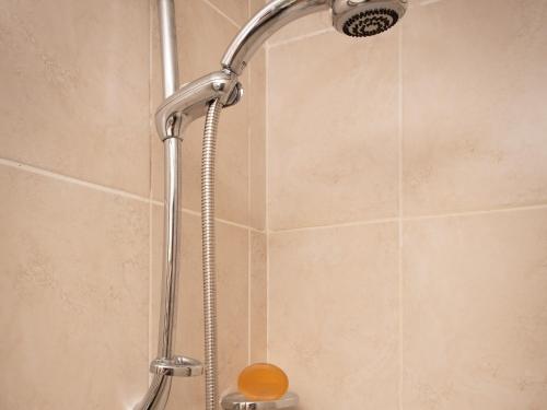 a shower with a shower head in a bathroom at Flat 4 in Keswick