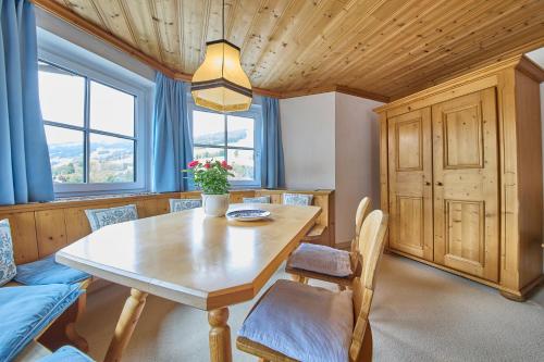a dining room with a wooden table and chairs at Appartements Bernhofer in Saalbach Hinterglemm