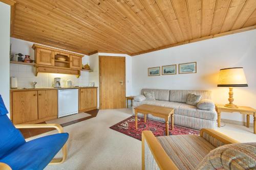 a living room with a couch and a kitchen at Appartements Bernhofer in Saalbach Hinterglemm