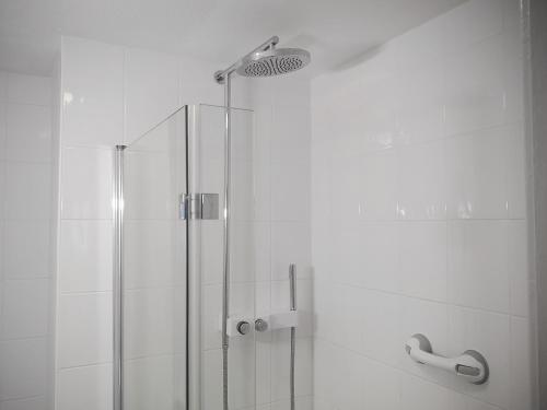 a bathroom with a shower with a glass door at Seascape - St Catherines Court in Fowey