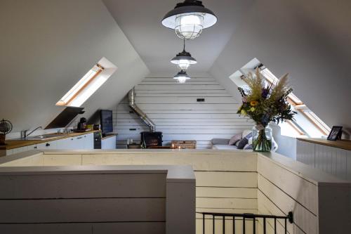 a kitchen with a counter with a vase of flowers at Rooms De Voerman in Ieper