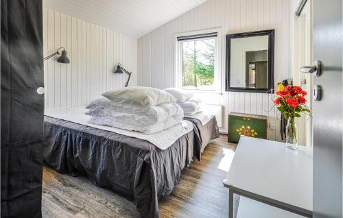 a bedroom with two beds and a window at bleskroget in Torsted