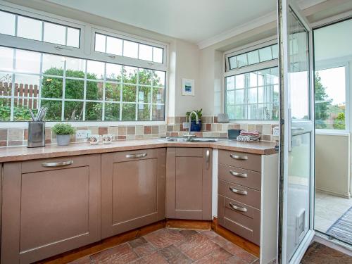 a kitchen with a sink and a glass shower at Tanglewood in Bugle