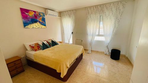 a bedroom with a bed and a picture of a ladder at Holiday with a sea view in Torrevieja