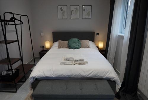 a bedroom with a bed with two books on it at Canary Wharf O2 Deluxe Ensuite Rooms in London