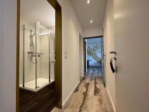 a bathroom with a shower and a glass door at Astrid's Appartements in Winterberg