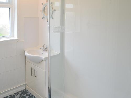 a bathroom with a shower and a sink at Sea Drift in Walcott