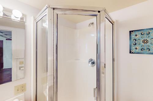 a shower with a glass door in a bathroom at Potter Place in Eugene