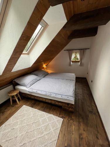 a bedroom with a bed in a attic at Hamerská chaloupka in Hlinsko
