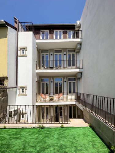 an apartment building with a lawn in front of it at Vibrant Host -Bonfim in Porto