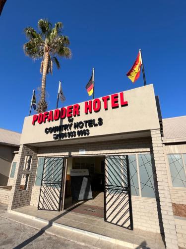 un panneau indiquant un hôtel avec un palmier derrière lui dans l'établissement Pofadder Hotel by Country Hotels, à Pofadder