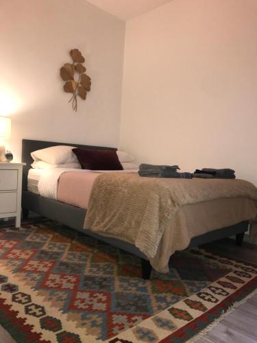 a bedroom with a bed and a rug at Saint Mandé Paris in Saint-Mandé