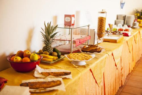 a table with a buffet of fruits and vegetables at Hotel Piccada in Palau