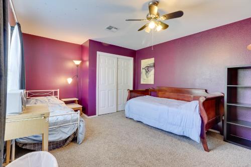 a bedroom with purple walls and a bed and a desk at Spacious Hutto Retreat with Large Private Backyard in Hutto