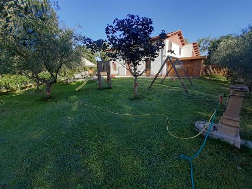 a yard with a playground with a hose at LE CERQUE in Spoleto