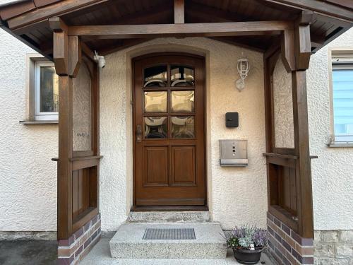 a wooden door of a house with a porch at Gästehaus Trockau in Pegnitz