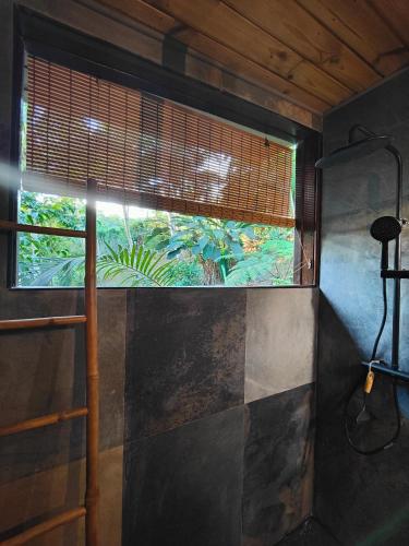 a window in a room with a view of an aquarium at OHANA Jungle Lodges in Les Avirons