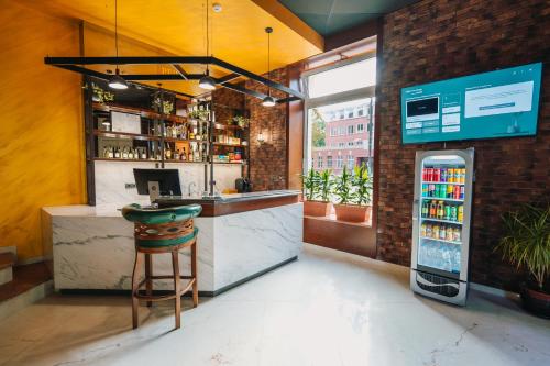 a bar in a restaurant with a counter and a stool at Хотел Театъръ in Pleven