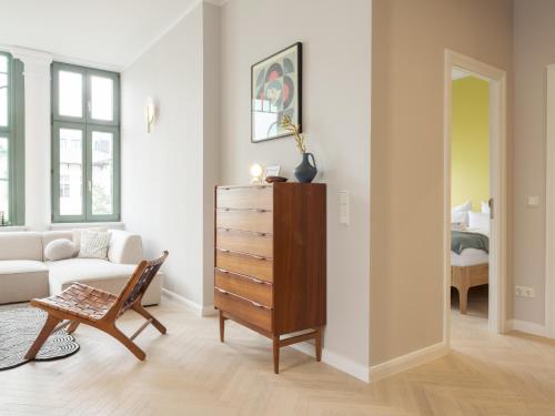 a living room with a dresser and a couch at OSTKÜSTE - Villa Steigel Design Apartments in Ahlbeck