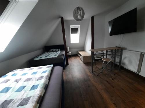 a bedroom with a bed and a desk and a tv at Villa Affenhaus in Treben