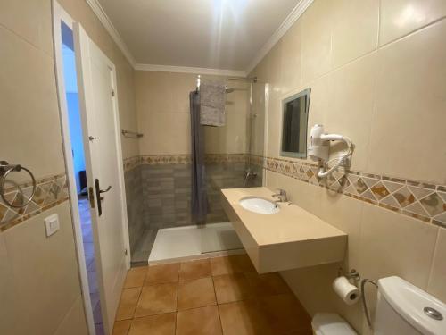 a bathroom with a sink and a shower at 60 El Sultan, 20 Pedroy Guy Vandaele in Corralejo