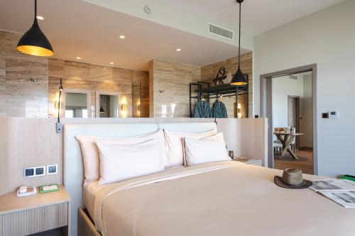 a bedroom with a large bed with white pillows at Ngorongoro Lodge member of Melia Collection - The Leading Hotels of the World in Ngorongoro