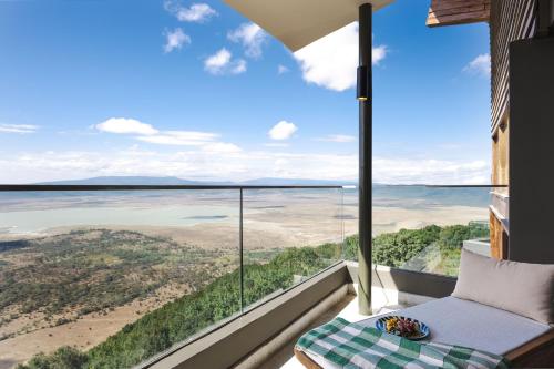 a room with a view of the ocean from a house at Ngorongoro Lodge member of Melia Collection - The Leading Hotels of the World in Ngorongoro