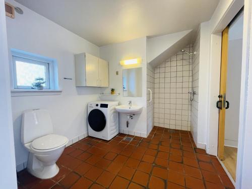 a bathroom with a toilet and a sink at aday - Central Terrace Apartment in Hjorring in Hjørring