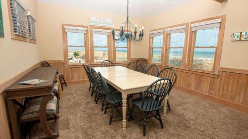 a dining room with a table and chairs at Oceanfront, Wild Horses, Ocean Views, Private Pool, 4x2251, Beauty & The Beach in Knotts Island