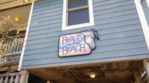 a sign on the side of a house with a horse on it at Oceanfront, Wild Horses, Ocean Views, Private Pool, 4x2251, Beauty & The Beach in Knotts Island