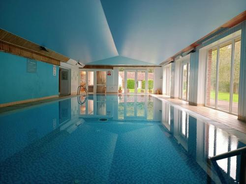 a large swimming pool with a swimming pool at Holbrook Manor & Spa in Wincanton