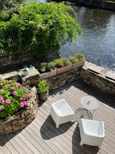 a patio with a table and chairs and flowers at Domeček / Tiny House in Český Krumlov